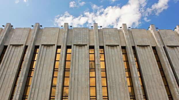 Facade top of the modern public art-house against blue sky background. Kyiv, Ukraine