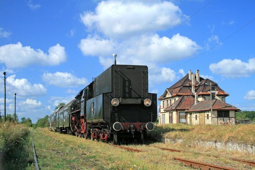 Old retro steam train stopped from the small station
