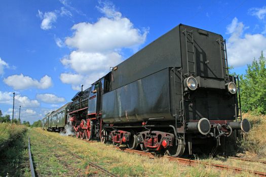 Old retro steam train stopped from the small station
