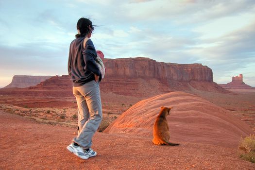 A girl and her dog mesmerized by the wonderful sunset