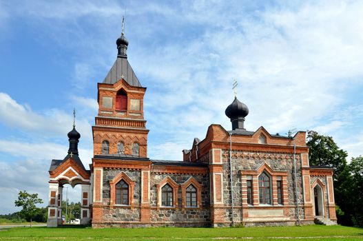 The church is constructed of a red brick and greater stones