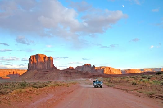 The main road of Monument Valley National Park at sunset