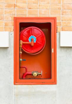 Hydrant with water hoses and fire extinguish equipment on wall