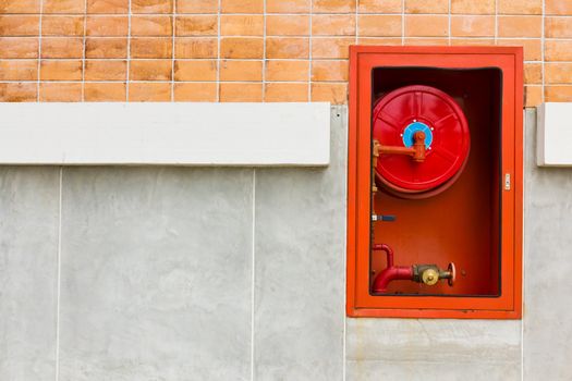 Hydrant with water hoses and fire extinguish equipment on wall