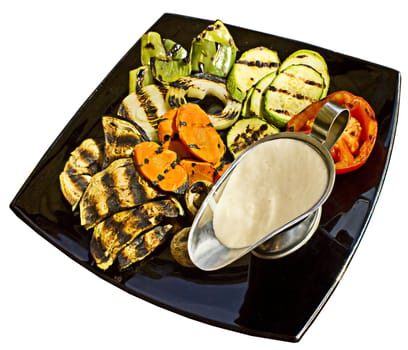 Grilled vegetables with milk sauce, isolated on white background.