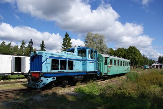 The train station is on a background of clouds and blue sky