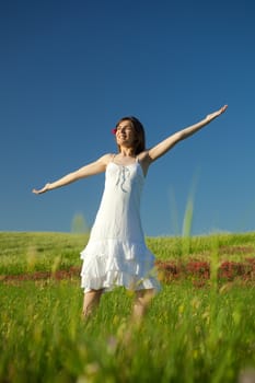 portrait of a beautiful young woman relaxing on the field