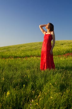 Beautiful young woman relaxing on the field