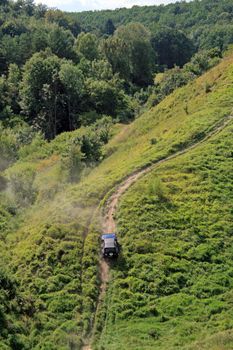 Off-road. 4x4 jeep tries to climb up top of a hill
