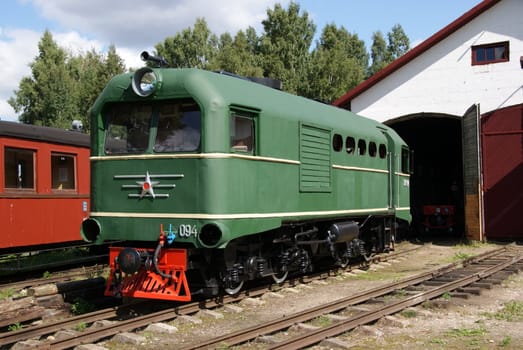 The locomotive of the narrow-gauge railway costs at depot