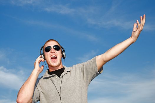 A cool young man listens to music on some headphones