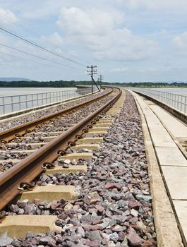 Railroad tracks curving  across the lake