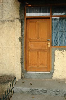 a wooden door in stone and brick wall