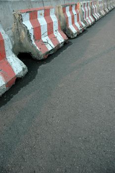 heavy concrete barricade seperating traffic lanes on track