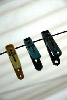a few cloth pegs hanging on a piece of string