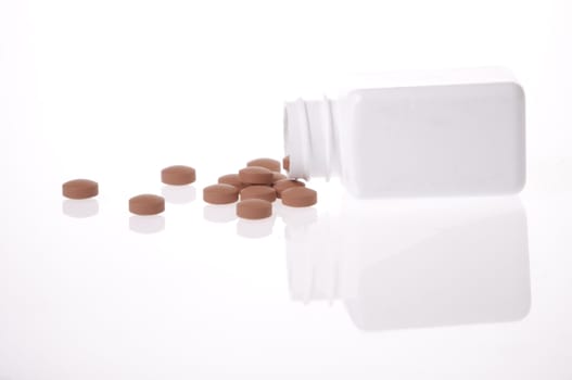 A white pill bottle with red generic pills on a white background.