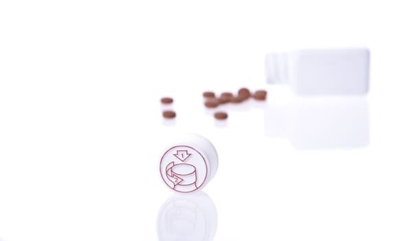 A white pill bottle with red generic pills  on a white background.