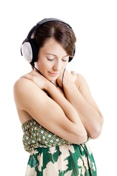 Beautiful young woman listen music with headphones, isolated on white