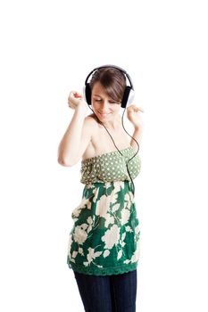 Beautiful young woman listen music and dancing with headphones, isolated on white