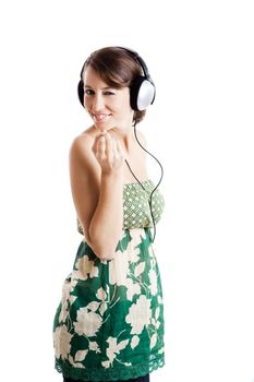 Beautiful young woman listen music and dancing with headphones, isolated on white