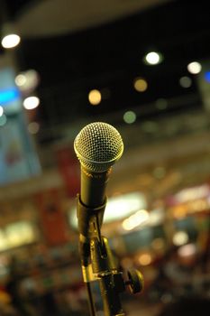 mic on stage with colorful background shallow depth of field