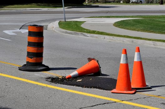 Orange traffic cones at road work site.