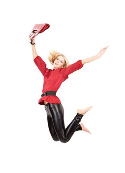 Jumping woman in red top and black leggins over white isolated background