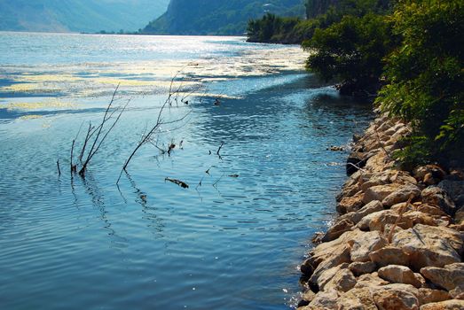 stone riverbank of Danube canyon in Serbia, blue water surface