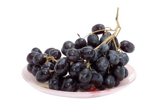 Bunch of black grapes on the plate; shoot over white background