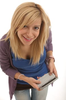 A smiling blonde girl using her smartphone