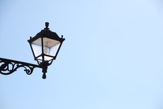 old vintage lantern against blue sky background