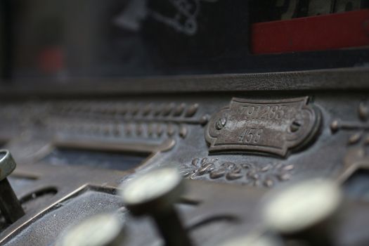 A close-up of an antique cash register