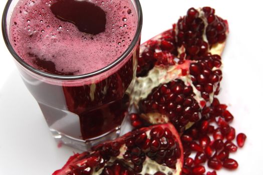 A fruit juice of pomegranate on white background