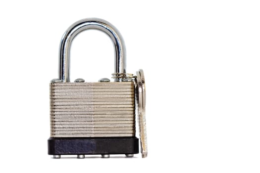 Close-up shot of a silver colored metal padlock with its key