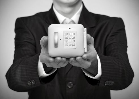 Business man holding a money safe