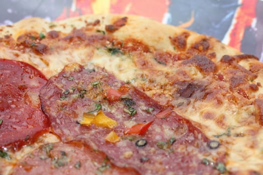 Italian pizza with salami and vegetables