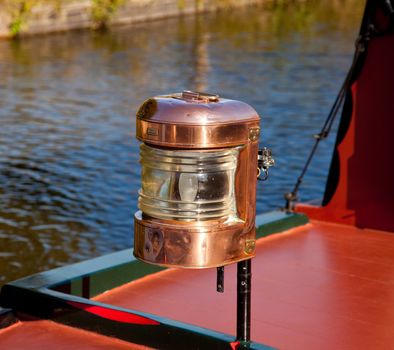 Polished brass lamp on the bow of a canal barge