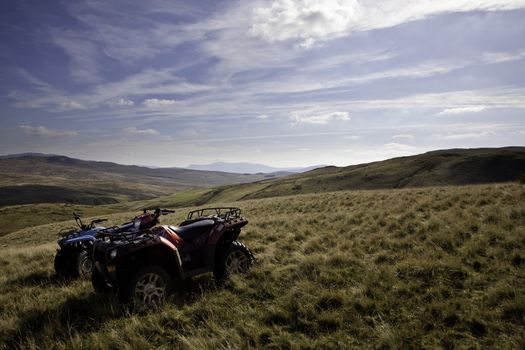 Off road quad bikes on mountainside in remote Welsh valley