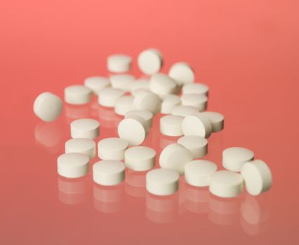 Pills towards red background