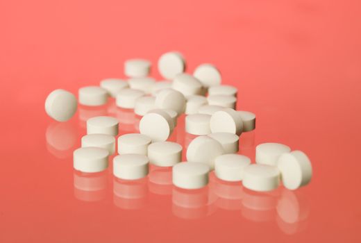 Pills towards red background