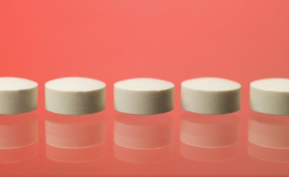 Pills toward red background