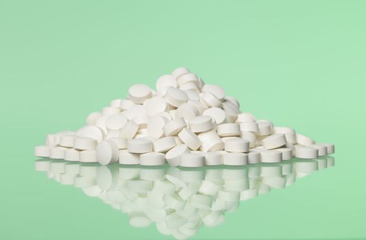 Stack of pills towards green background