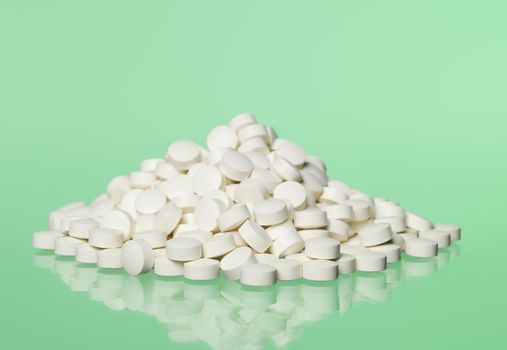 Stack of pills towards green background