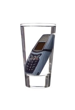 Mobile in telephone a glass of water