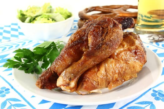 a roast chicken with salad on a plate
