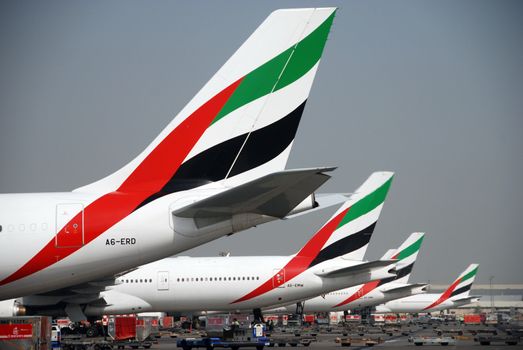 Many planes at the parking area, waiting to leave