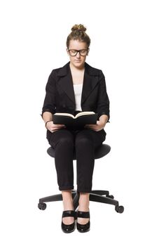 Buisnesswoman sitting on a chair with a book