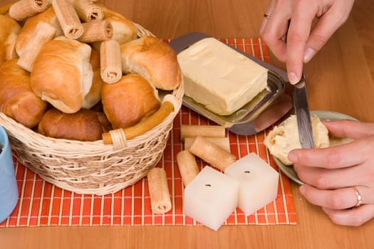 A basket with fresh baked bun and croissants.  