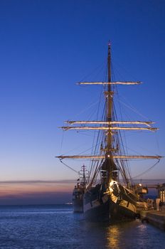 Moored sailing ship at sunset