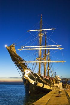 Moored sailing ship at sunset